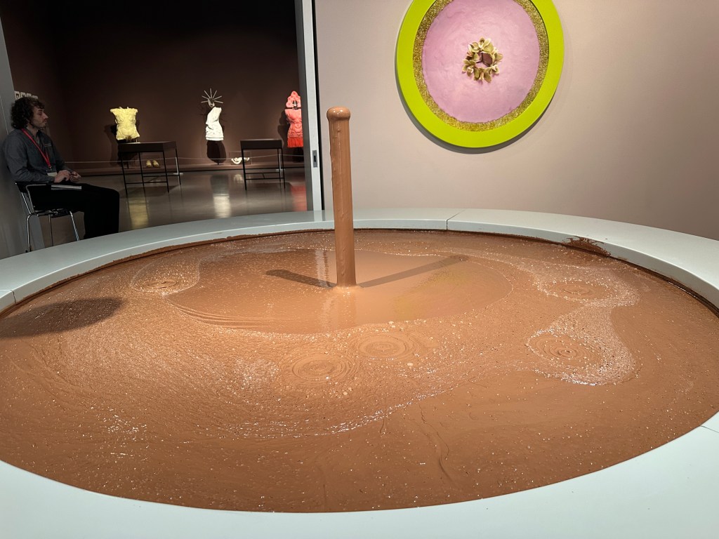 A large circular vat filled with melted chocolate